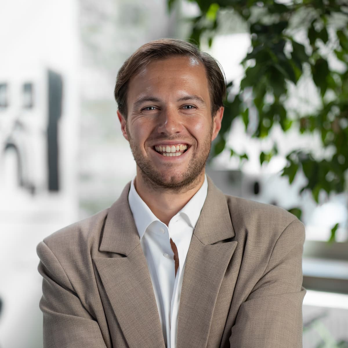Niels Kaspers, Principal Product Manager at Picsart, smiling in a professional headshot wearing a tan blazer in a modern office setting